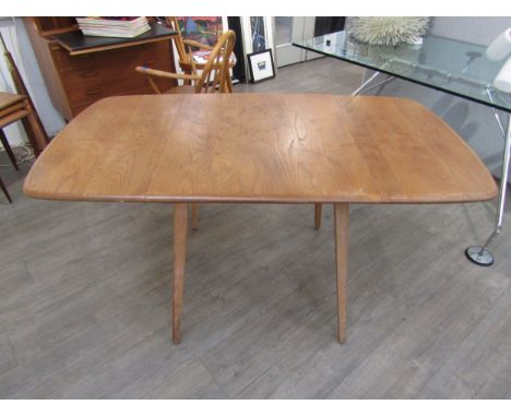 An Ercol light elm finish dining table, square top with twin lift up extensions. Measurement fully extended 137cm x 74.5cm x 