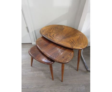A 1960's Ercol nest of three elm 'Pebble' tables