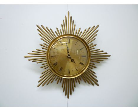 A Junghans electronic sunburst wall clock. 46cm diameter 