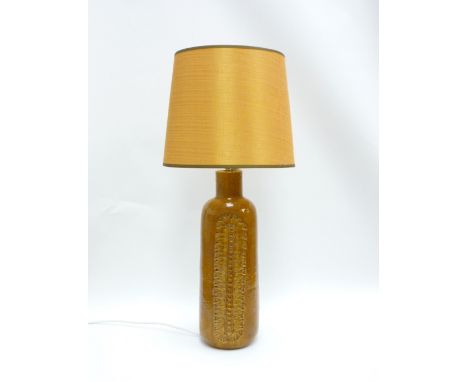 A Bitossi ceramic lamp base in mustard glaze with impressed motif detail, associated shade. Base and fitting approx 50cm high