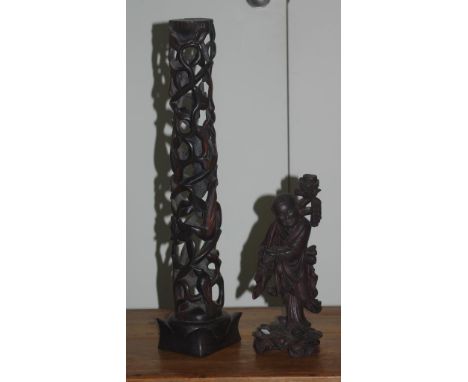 Two vintage Chinese carvings to include a carved ebony column and a good luck man figure, 57cm high and 31cm high approx