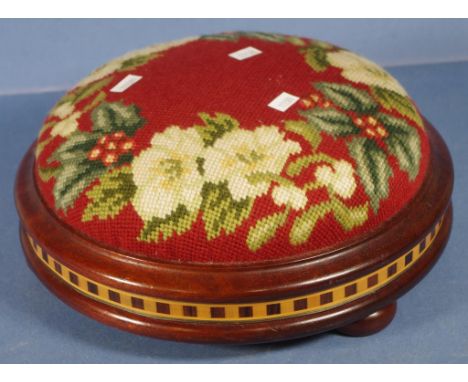 Vintage embroidered footstool hand embroidered floral pattern tg top. Inlaid decoration to edge of wooden base. Diameter 28cm
