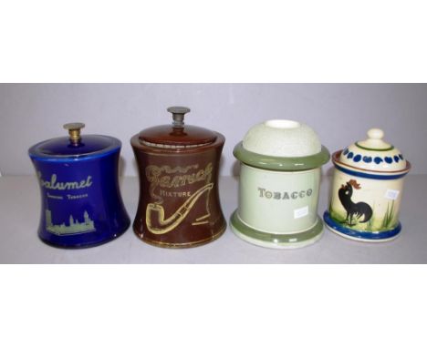 Four various vintage tobacco jars including 1 marked "Calumet" smoking tobacco; another marked "Garrick Mixture," both with p