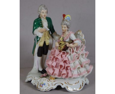 Dresden courting couple figure woman playing a mandolin, marked to base. Height 22cm approx.