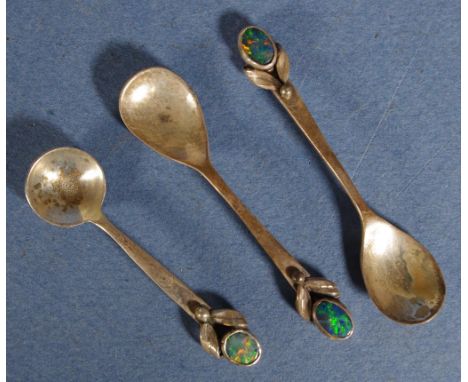 Three silver opal decorated condiment spoons including 2 mustard spoons and 1 salt spoon. Each marked sterling, with opal dec