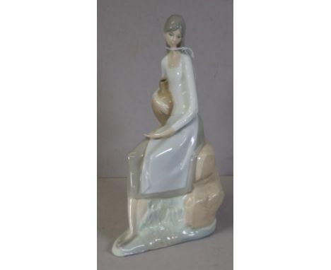 Nao seated young woman figure stamped to base. Height 27cm approx.