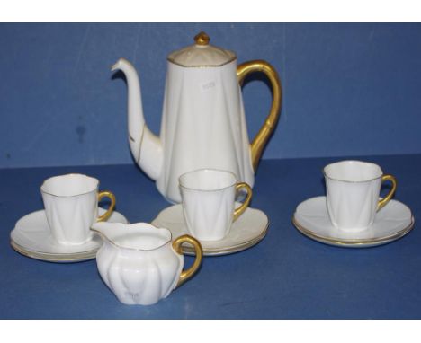 Eleven piece Shelley part coffee set white with gilt borders, including 3 cups, 5 saucers, cream jug and coffee pot.