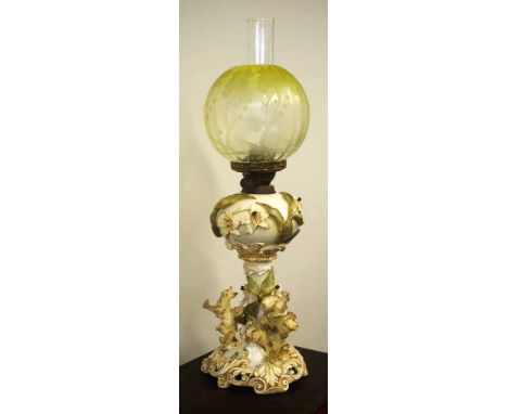 Victorian Moore Bros oil lamp with scrolled base and raised botanical form decoration, factory mark and design registration n