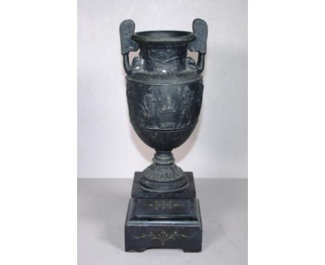 Vintage cast metal twin handle urn on hard stone base, in relief figural decoration to centre,height 31cm approx