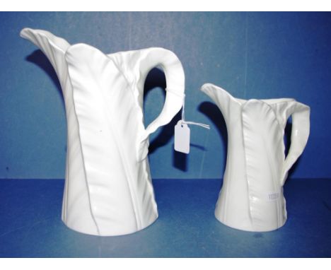 Graduated pair Royal Worcester jugs figural leaf decoration in relief. Height 15cm and 21cm approx (each). Height 15cm and 21