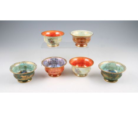 A group of six early 20th Century Wedgwood lustre bowls, two having pale coloured exteriors with mottled orange interiors ext