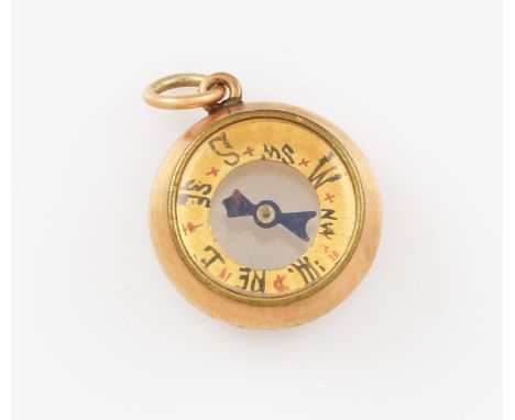 A Victorian 9ct yellow gold framed compass charm, of circular form featuring red letters to one side and blue to the other, h