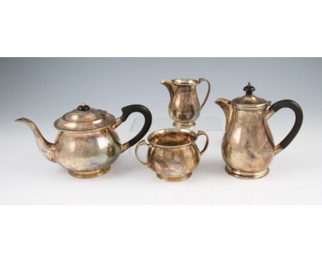 A matched four piece silver tea service, consisting of a tea pot, water jug, sugar bowl and milk jug, all of baluster form an