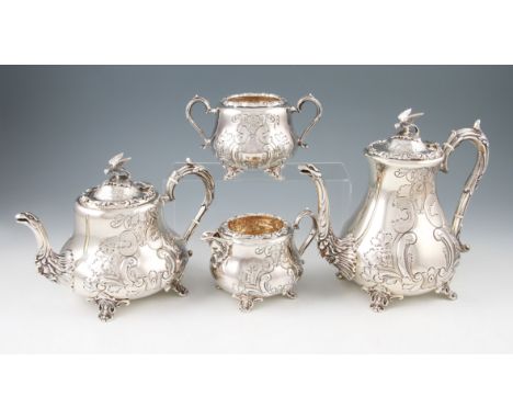 A silver four piece tea set comprising of tea pot, water pot, milk jug and sugar bowl, each having foliage and scroll decorat