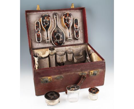 A George V travel set, consisting of two hand brushes, two hair brushes, a hand mirror, a hinged trinket box, a long faceted 