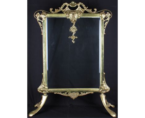 A mid 19th Century Victorian brass fire screen with Rococo decorated frame with ornate and scroll design with splayed feet, h