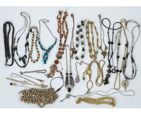 An assortment of silver and costume jewellery. Includes a silver and amber bangle, a silver and black stone necklace, a silve