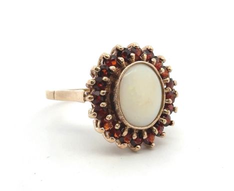 A 9ct yellow gold opal and garnet cluster ring. Size P. Weight 6.42g.