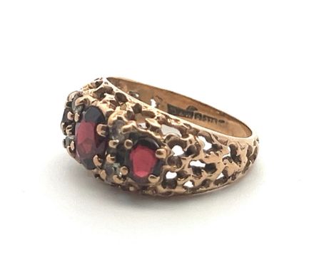 A 9ct gold and garnet ring with white stone accents, size M. Birmingham hallmarks, Sponsor D&amp;W.