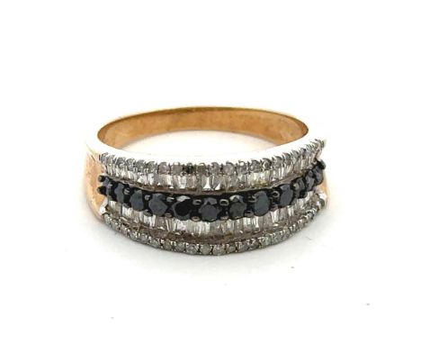 A diamond and sapphire five row ring set in hallmarked 9ct yellow gold. A central row of round cut sapphires is flanked on bo