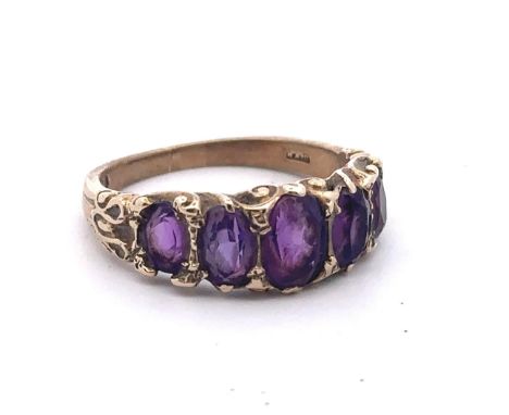 A 1960s five stone amethyst ring set in 9ct gold with scroll shoulders, size N. Sponsor S&amp;KH. Weight 3.59g. Size N.