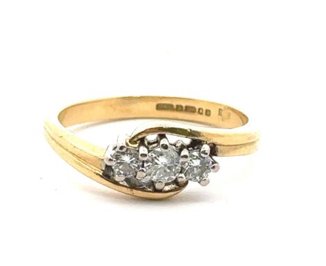 An 18ct yellow gold three stone diamond ring, size J. Estimated diamond weight 0.24ct. London 2000 hallmarks, sponsor D&amp;E