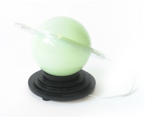 A desk lamp, the globular glass shade with a detached mirrored and perspex band on a staggered base, in the form of a planet 