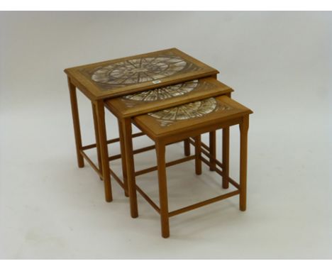 A nest of three 1970's teak tile topped coffee tables, max. w. 55 cm