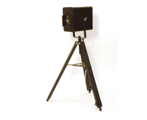 A Strand Electric black metal theatre spotlight on a matching tripod base