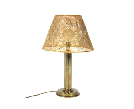 A brass table lamp, the pierce-work shade depicting floral sprays on a straight column and circular plinth, by Robert Goossen