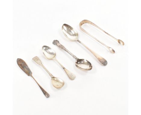 An assortment of antique and later silver hallmarked flatware. The lot to include four assorted spoons, a butter knife and a 