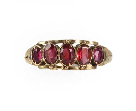 A Victorian gold rhodolite garnet five stone ring,  with five graduated oval mixed cut rhodolite garnets in pinched collet se