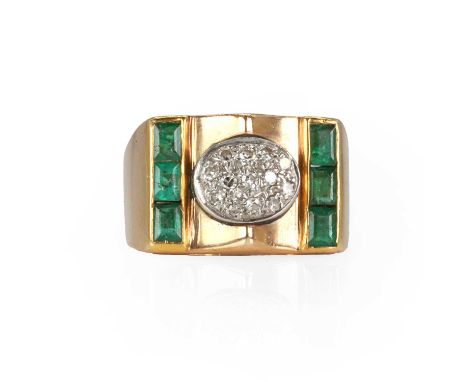 A diamond and emerald signet ring,  with a central boss pave set with single cut diamonds, flanked by channel set calibre cut