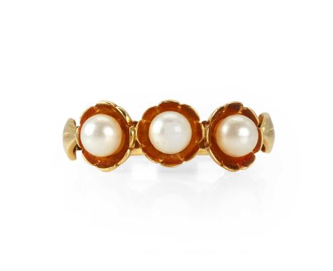 An 18ct gold simulated pearl three stone ring, with three simulated pearls, all set to floral cups, with leaf shoulders, all 
