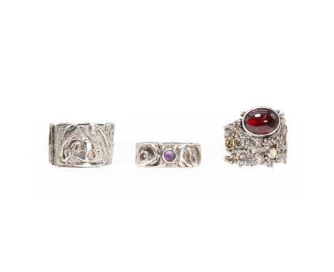A group of three silver rings, c. 1970, comprising:a silver amethyst ring,with a round amethyst cabochon, bezel set to a text