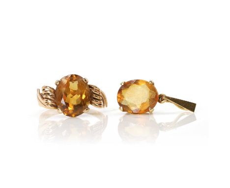 A citrine ring and a citrine pendant, the ring with an oval cut citrine, four claw set, to curled wire shoulders and a D prof
