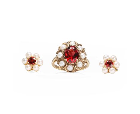 A 9ct gold garnet and seed pearl ring and earrings set, the ring with an oval cut garnet, claw set to a surround of seed pear