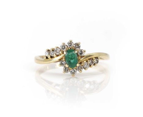 An 18ct gold emerald and diamond cluster ring,  an oval cut emerald, claw set centrally to a crossover cluster surround of ro