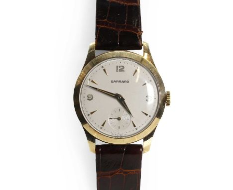 A gentlemen's 9ct gold mechanical strap watch, by Garrard,  with a 31mm diameter case, a silvered dial, gilt baton hour marke