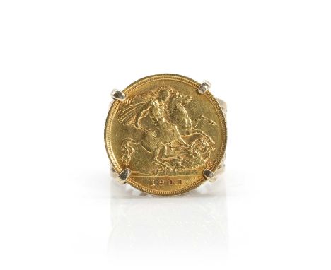 A half sovereign coin ring, an Edward VII half sovereign, dated 1908, claw set to a reeded collet, into a pierced scrolling s