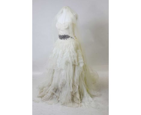 A Vera Wang wedding dress and veil, of recent manufacture, the dress in white with a layered pleated tulle and lace skirt, el