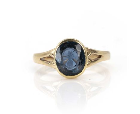 A 9ct gold sapphire doublet ring,  the oval cut doublet rub over set to pierced shoulders and a plain hoop, London 2006, 4.05
