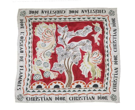 A Dior 'L'Oiseau de Flammes' silk scarf, of recent manufacture, in tones of pink, green, orange and brown to a cream ground, 