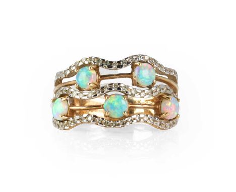 A 9ct gold five row opal and diamond band ring,  with rows of cabochon opals claw set between wavy rows of eight cut diamonds