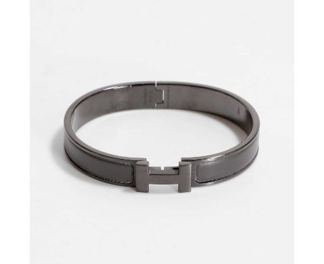 A Hermes black click 'H' bangle, the inner stamped Hermes, FI 12 22, and Made in France, with original box, the inner dimensi