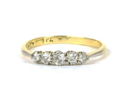 A gold five stone diamond ring, five Swiss cut diamonds, claw set to a plain polished shank, tested as approximately 18ct gol