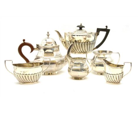 A three piece silver bachelors tea service, by S Blanckensee, together with another similar three piece set, approximately 35