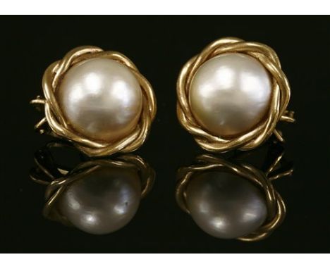 A pair of 9ct gold mabé pearl earrings, with a 14.5mm mabé pearl, peg set to a twisted wire border, with post and Omega fitti