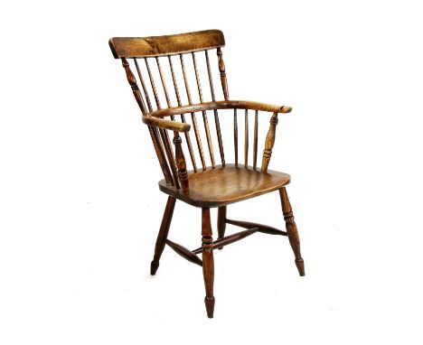 A 19th century ash and elm comb back chair, probably Lincolnshire, with turned outer supports and on four turned legs joined 