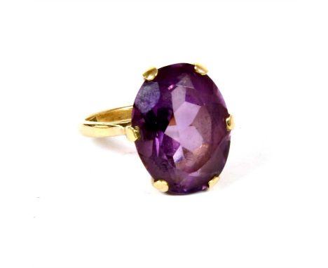 A single stone amethyst ring, a mixed cut oval amethyst, six claw set to an open gallery and a plain polished shank, marked 9
